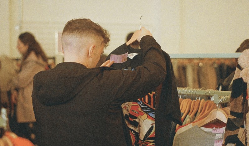 Photo of a man browsing vintage clothes